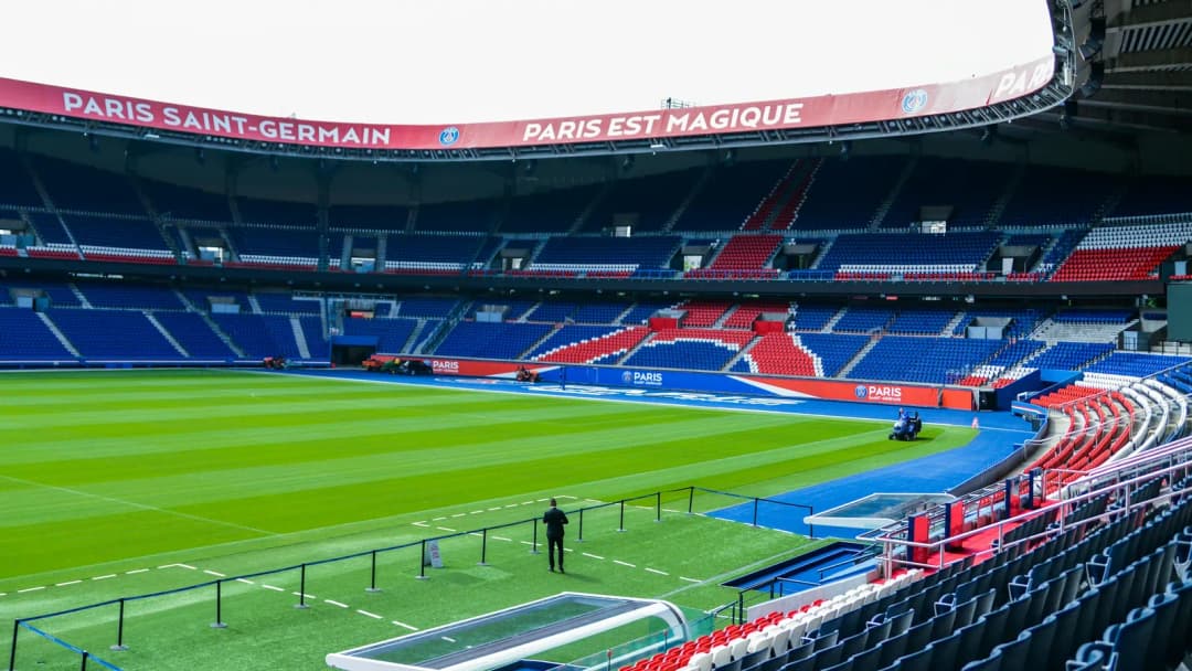 Parc des Princes stadium with rows of blue and red seats around a green pitch
