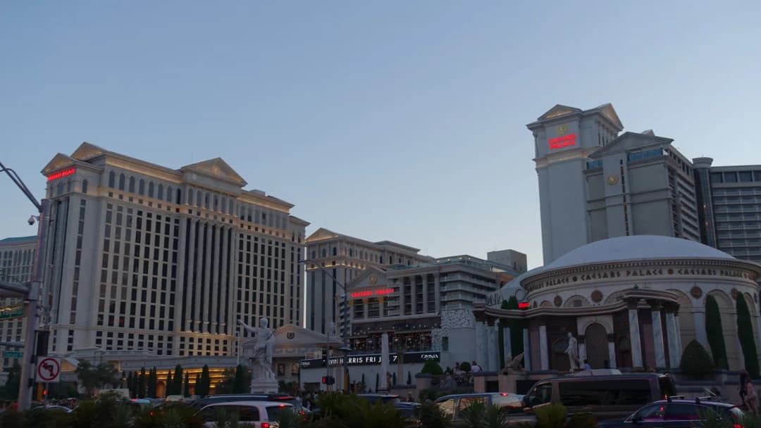 Caesars Palace resort on the Las Vegas Strip, its Roman-style facade and dome seen from the street.
