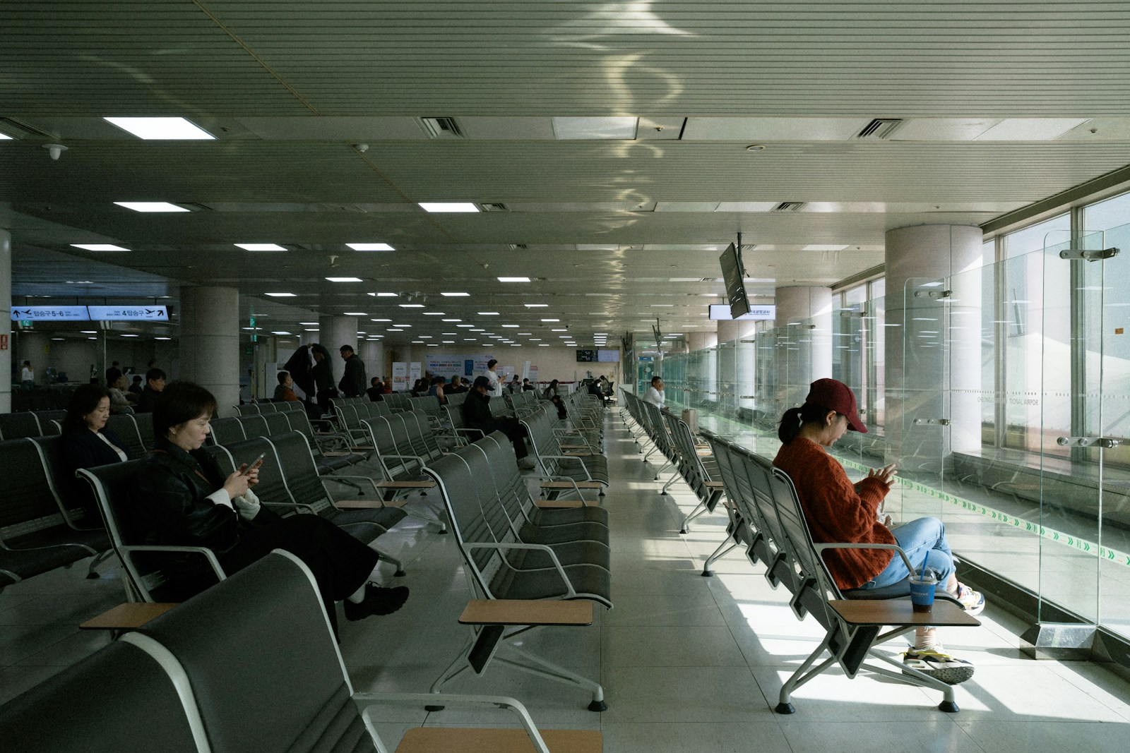 Travelers waiting in a modern airport terminal, the Atmos migration changed the storefront, not the core mechanic